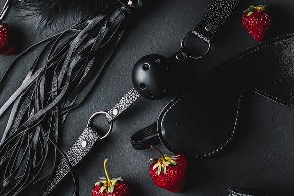 bdsm kink black accessories with strawberries