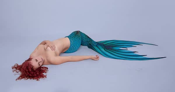 A topless sexy mermaid representing a paraplegic woman.